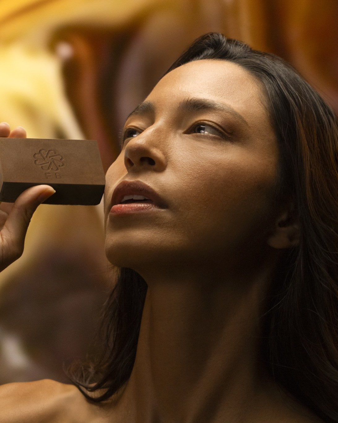 Woman holding a JIVANTRA solid cleansing bar